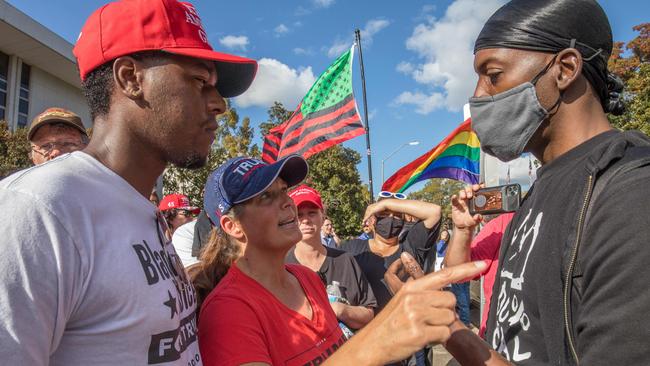 Trump supporters (L) and Black Lives Matter supporters debate in front of the North Carolina Capitol in Raleigh, North Carolina, during a "Protect The Results" rally on November 7. Picture: Getty