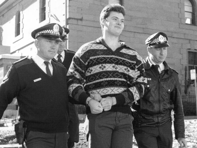 Robert Steele is led away by police after the Cangai farmhouse siege