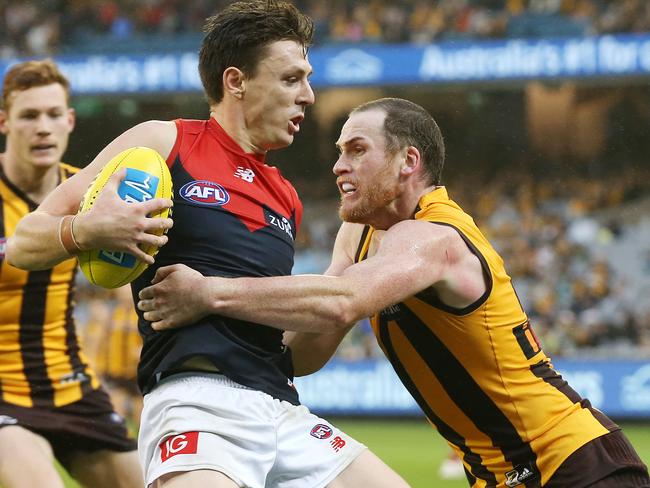 AFL Round 4. 15/04/2018. Hawthorn v Melbourne at the MCG. Melbourne's Jake Lever gets caught by a strong Jarryd Roughead tackle 4th qtr   . Pic: Michael Klein