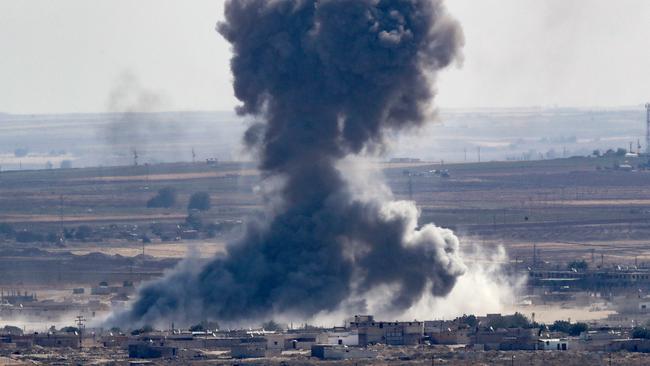 Smoke rises over the Syrian town of Ras al-Ain, after multiple air strikes. Picture: Getty Images.