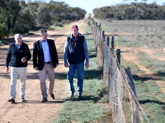 EYRE PENINSULAR FUNDING ANNOUNCEMENT - Minister Tim Whetstone visits Ceduna. Geoff Power (Orroroo Farmer and Chairman of the SA Dog Fence Board), Tim Whetstone, Craig Trowbridge (Chairman of the Penong Dog Fence Board) look at an old semi repaired part of the dog fence 40kms west of Ceduna. Picture: Tricia Watkinson