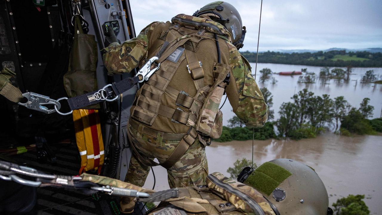 Australian Army aircrewman Sergeant Rick Scott (top) from the School of Army Aviation conducting a rescue from an MRH-90 Taipan helicopter near Lismore. Photo: AFP PHOTO / AUSTRALIAN DEFENCE FORCE