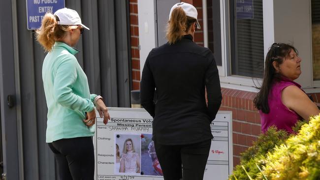 Women gather in front of a missing persons poster of Ballarat East woman Samantha Murphy outside the Buninyong Police Station. Picture: NCA NewsWire / Ian Currie