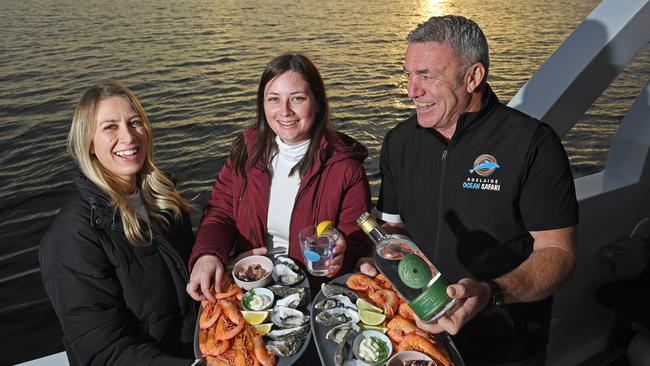 Verity Beswick and Ashleigh Beaumont from Glenelg North with Tony Coppins, owner of Adelaide Ocean Safari, ahead of the Indigenous Flavours on the Sea event as part of Tasting Australia Local. Picture: Tom Huntley