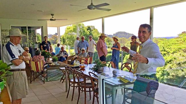 Ray White auctioneer Brett Graham takes bids at 33 Eckersley Ave, Buderim, on Saturday with marketing agents Lew Pottinger and Judy Wild. Picture: Erle Levey