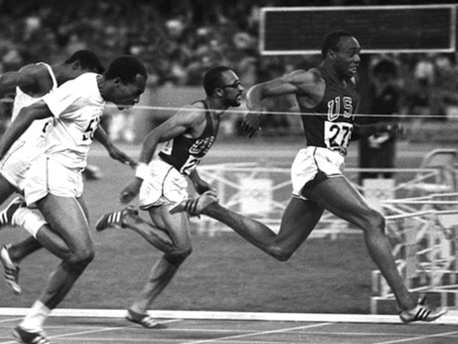 Jim Hines breaks the tape to win the 100m dash during the Olympic Games in Mexico City.