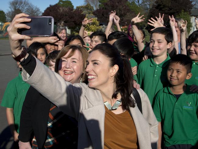 Ardern takes a selfie with schoolchildren during a visit to Addington School in Christchurch, New Zealand. Picture: Mark Baker/AP