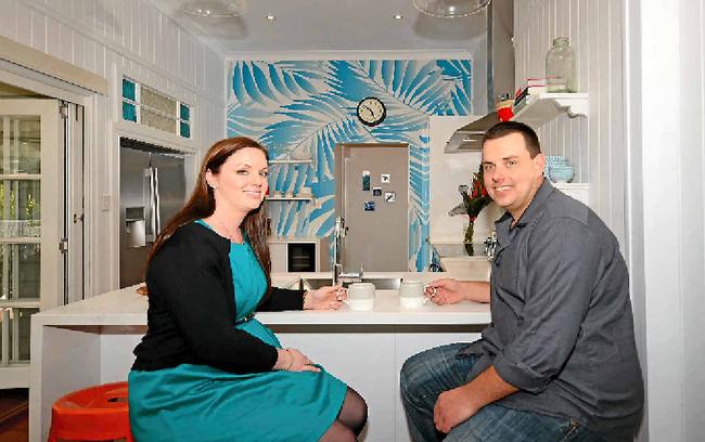 SMILES ALL ROUND: South Australian couple Jessica Yates and Jarrod Bennett sit in the kitchen of their new home in Toogoom. Picture: Seven Network