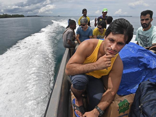 Asylum seekers take urgently needed foods and medicines back to the detention centre by boat. Picture: Brian Cassey