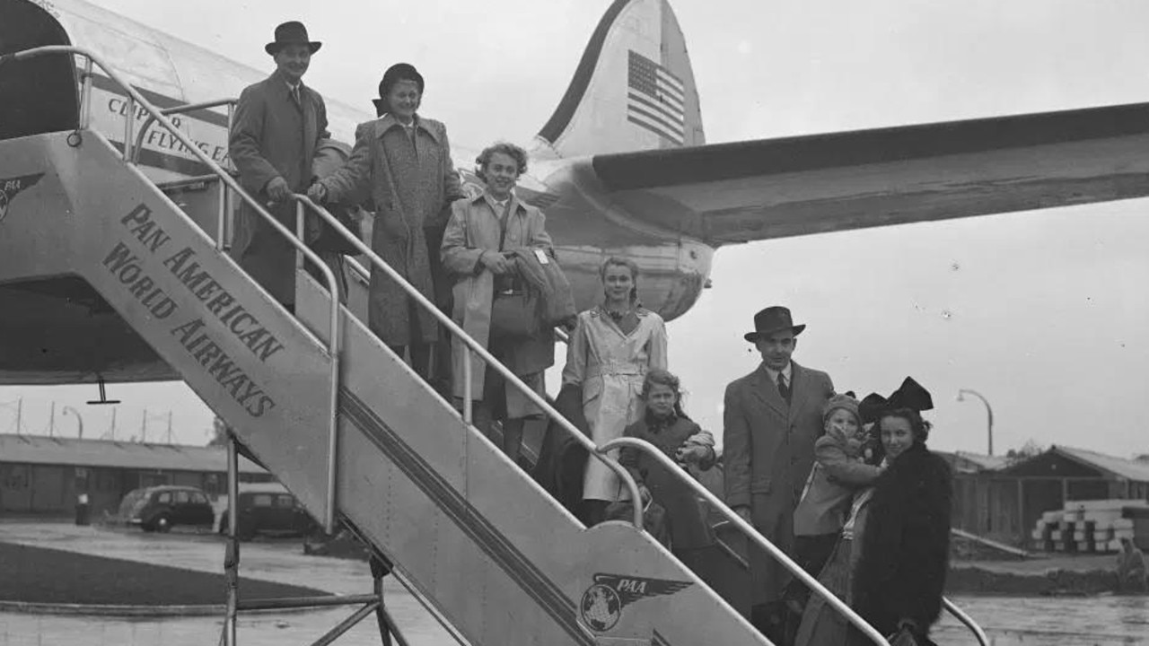 Members of the Braine family boarding their plane before the start of their long flight. Most immigrants came by ship but in later years, some travelled by plane.