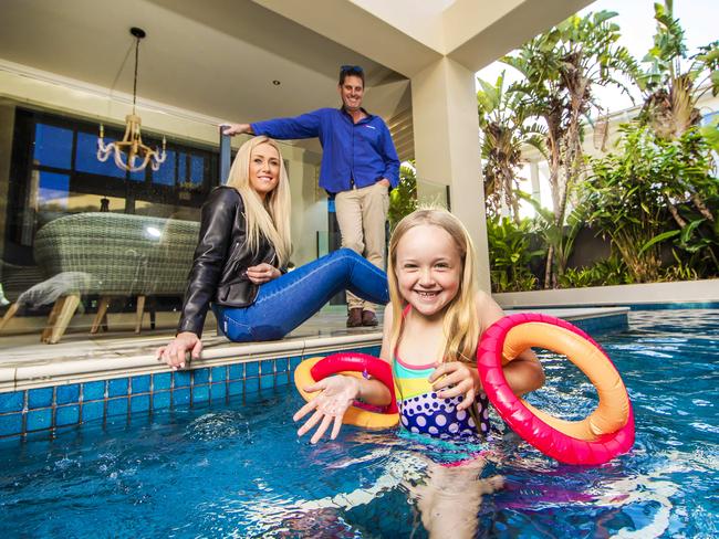 Ash and Andy Smith with their 7-year-old daughter Ayla who are selling their property on Sovereign Islands to go with spring selling season story. It's a good time to be selling with lots of buyers and low listings.Picture: NIGEL HALLETT