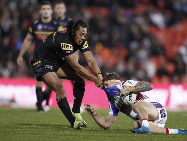 Luai ragdolls Kurt Mann of the Knights in a tackle. Picture: Jason McCawley/Getty Images