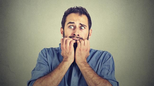 Portrait anxious young man biting his nails fingers freaking out, frightened, generic, scared