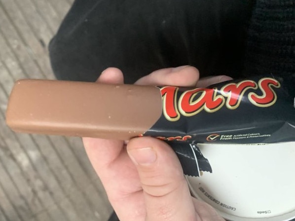 A UK man has received $3.91 in compensation and an apology after purchasing a Mars bar that was lacking its signature ripple. Picture: SWNS/Harry Seager