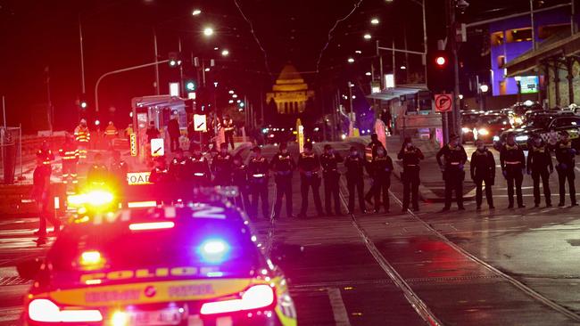 Police form a road block during an anti-lockdown protests in Melbourne. Picture: AFP.