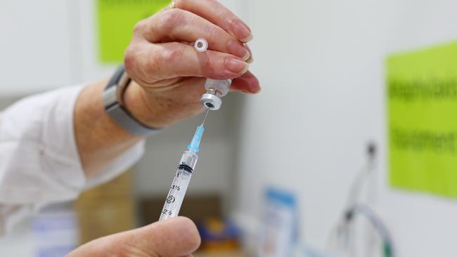 A nurse handles a COVID-19 AstraZeneca vaccine vial. Picture: Lisa Maree Williams/Getty Images