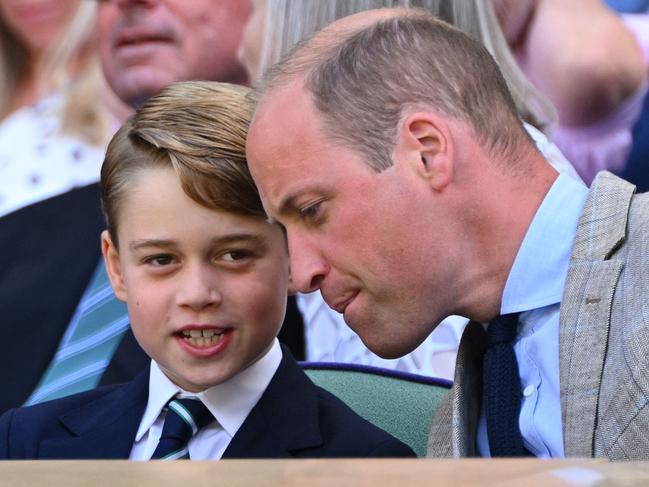 Britain's Prince William, Duke of Cambridge (R) talks to his son Prince George as they attend the men's singles final tennis match between Serbia's Novak Djokovic and Australia's Nick Kyrgios. Picture: AFP