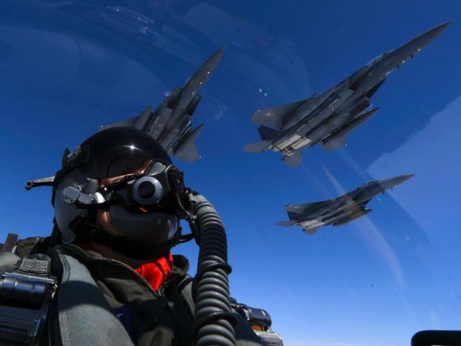 A US air force pilot joins up with Republic of Korea air force F-15s during a 10-hour mission from Andersen air force Base, Guam, into Japanese airspace and over the Korean Peninsula on July 30. Picture: US AIR FORCE/AFP