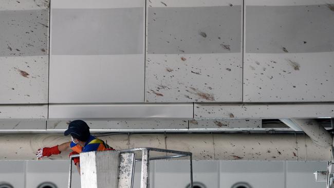 A worker wipes traces of blood from the wall of Ataturk Airport in Istanbul. Picture: AP