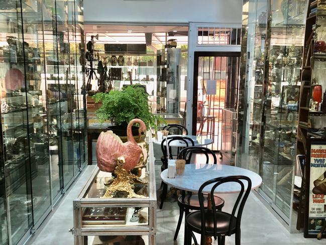 Glass cabinets filled with artefacts overflow in the cafe.