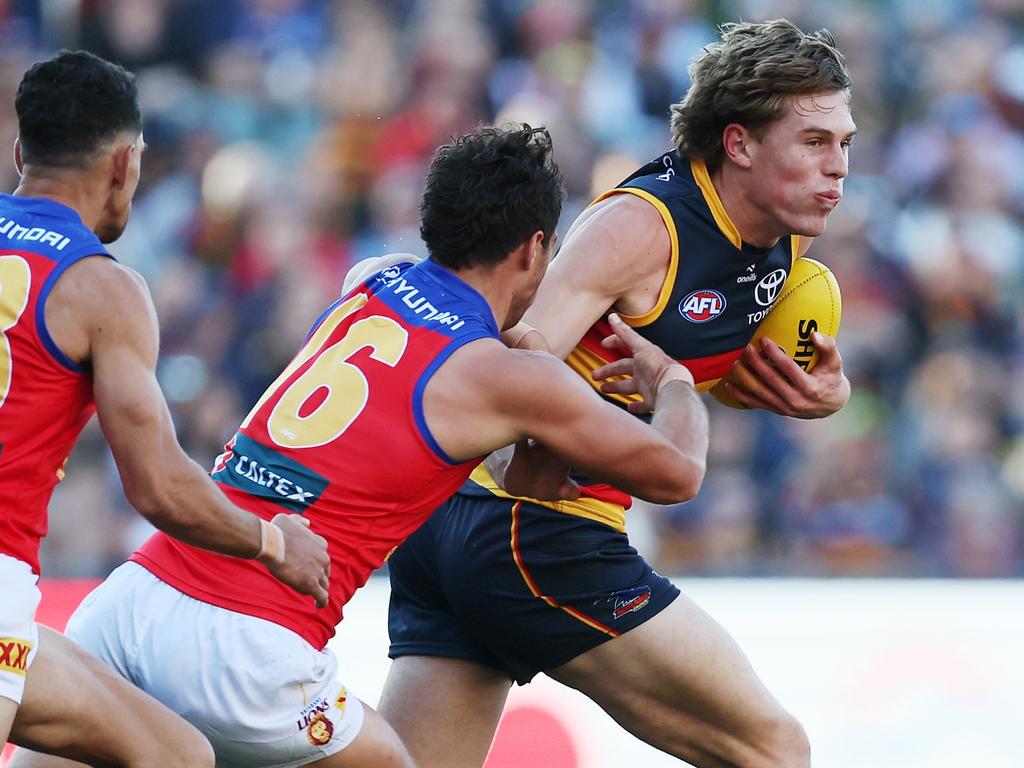 ADELAIDE, AUSTRALIA - MAY 02: Cam Rayner of the Lions tackles Daniel Curtin of the Crows during the 2024 AFL Round 08 match between the Adelaide Crows and the Port Adelaide Power at Adelaide Oval on May 02, 2024 in Adelaide, Australia. (Photo by James Elsby/AFL Photos via Getty Images)