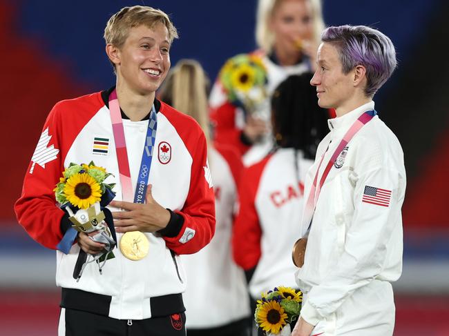 Quinn speaks with Megan Rapinoe after winning gold with Canada at the Tokyo Olympics. The midfielder became the first openly-transgender athlete to win an Olympic gold medal. Picture: Naomi Baker/Getty Images