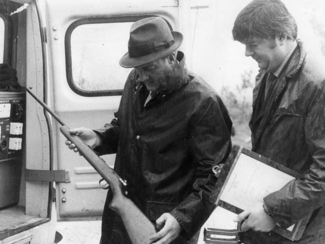 1971: Senior Constable L.E. Oliver, of the forensic science squad, examines a single-shot .22 calibre rifle after a mass murder at a home in Hope Forest, South Australia. Two women and eight children died. Clifford Bartholomew was convicted over the murders of his wife Heather, their seven children, his sister-in-law and her infant child. File picture