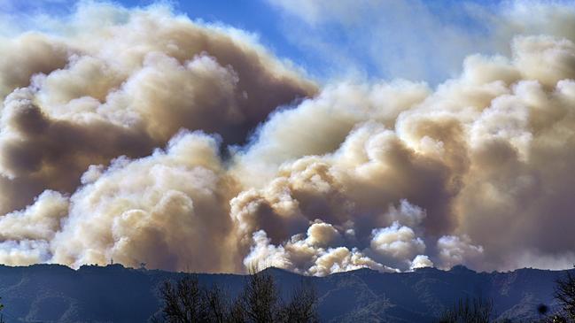 Smoke from the Palisades Fire rises over a ridge as seen from the Encino section of Los Angeles on Saturday. Picture: AP Photo