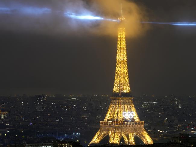 PARIS, FRANCE - JULY 26: A laser show is projected from the Eiffel Tower in Paris, France, during the opening ceremony of the 2024 Summer Olympics, Friday, July 26, 2024. (Photo by Brian Inganga - Pool/Getty Images)