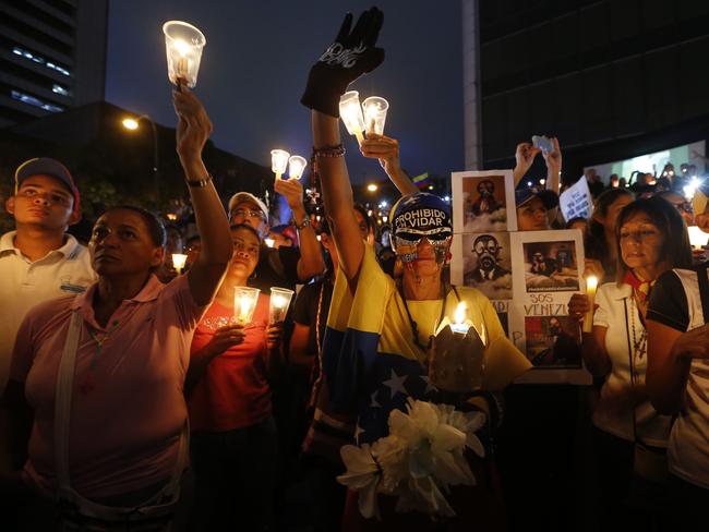 Demonstrators hold candles during a vigil for the victims of the clashes with the Venezuelan government security forces. Picture: Ariana Cubillos