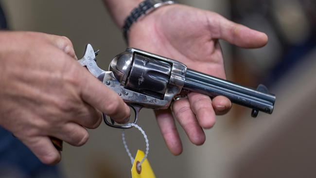 Props expert Guillaume Delouche holding a prop gun which may have been similarly to the one Alec Baldwin was using on set. Picture: David McNew / AFP.