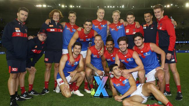 Melbourne game analyst Craig Jennings (left) with the Demons’ AFLX team. Picture: Michael Klein