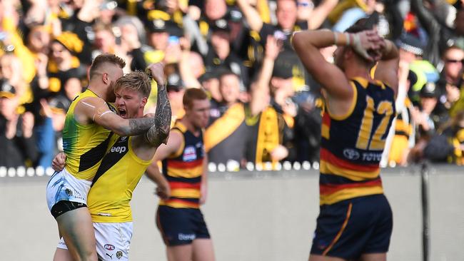 Brandon Ellis and Nathan Broad of the Tigers celebrate their 2017 premiership triumph over Adelaide.