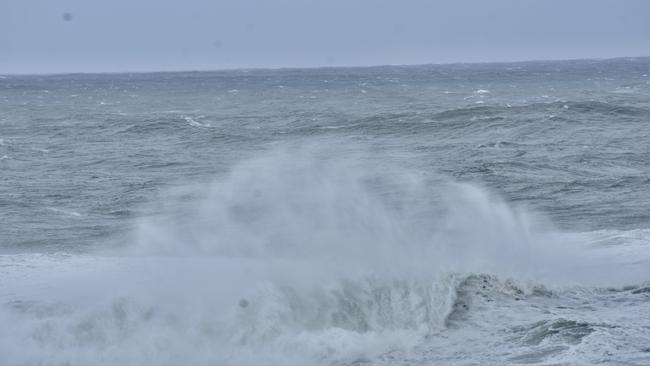 The wild surf gathered a bunch of onlookers hoping to take pictures. Picture: Tessa Flemming