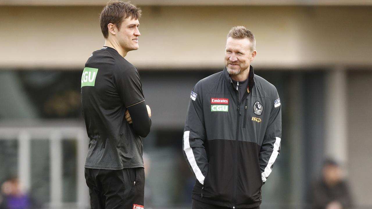 Nathan Buckley speaks with Darcy Moore during a training session at the Holden Centre.