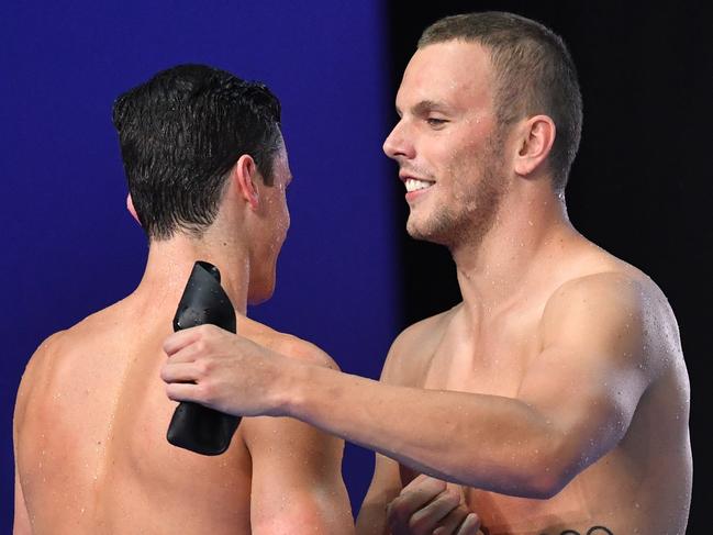 Kyle Chalmers (right) celebrates winning the final of the mens 100 metre Freestyle with second placed Jack Cartwright (left) during day two of the 2018 Australian Swimming Trials at the Gold Coast Aquatic Centre at Southport on the Gold Coast, Thursday, March 1, 2018. (AAP Image/Darren England) NO ARCHIVING, EDITORIAL USE ONLY