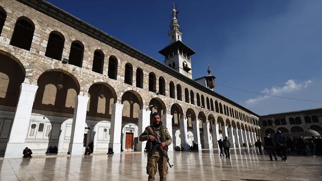 A rebel fighter in the Ummayad Mosque ahead of Friday noon prayers in Damascus on December 13. Picture: Sameer Al-Doumy / AFP