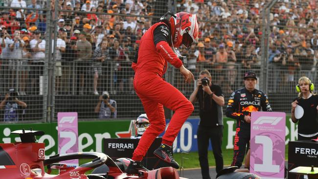 Ferrari's Monegasque driver Charles Leclerc comes out of his car to celebrate pole position