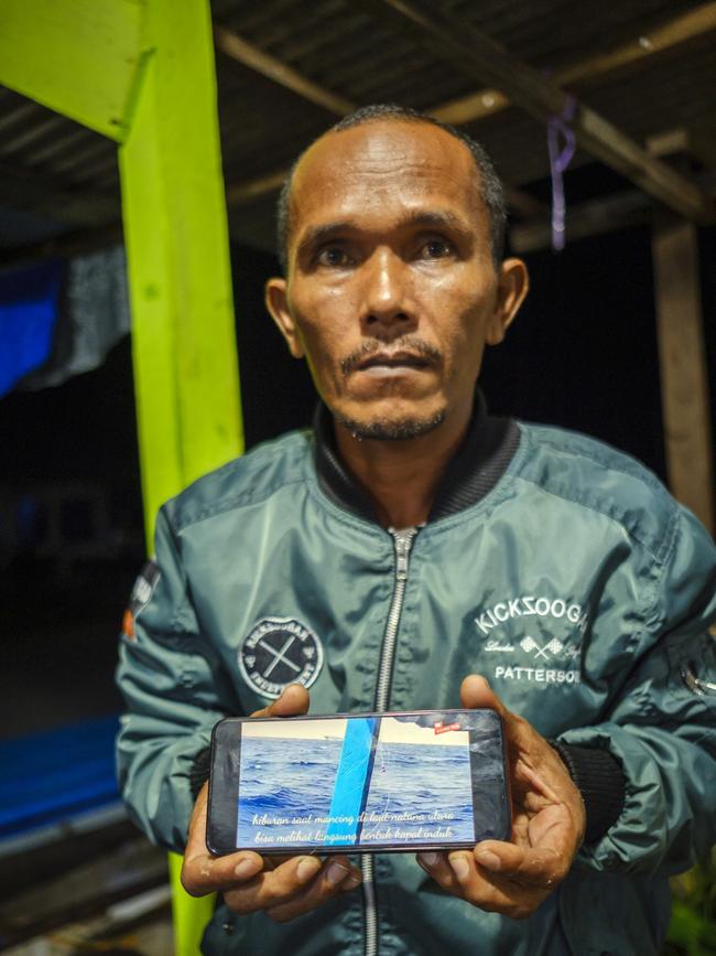 Dedi Saleh shows a video he took while he was out fishing, at a fishing port in Ranai, Natuna Regency. Picture: Jiro Ose