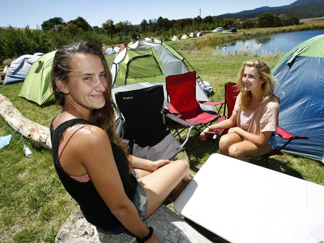 Fruit pickers Pauline Pinol, left, and Sarah Lou Valero, both of France, relaxing around the pickers’ tents at Lowdina Orchards. Picture: KIM EISZELE