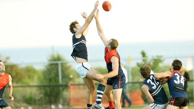 Declan Reilly of  Caulfield Grammarians.in a ruck duel with  Old Brighton’s Tom Skewes.