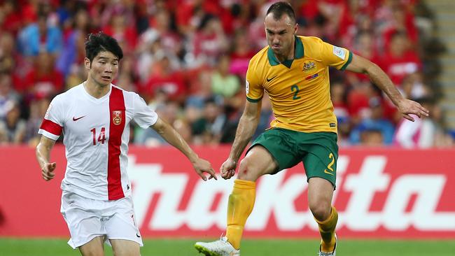 Australia's Ivan Franjic kicks the ball away rom China's Ji Xiang, left, during the AFC Asia Cup quarterfinal soccer match between China and Australia in Brisbane, Australia, Thursday, Jan. 22, 2015. (AP Photo/Tertius Pickard)