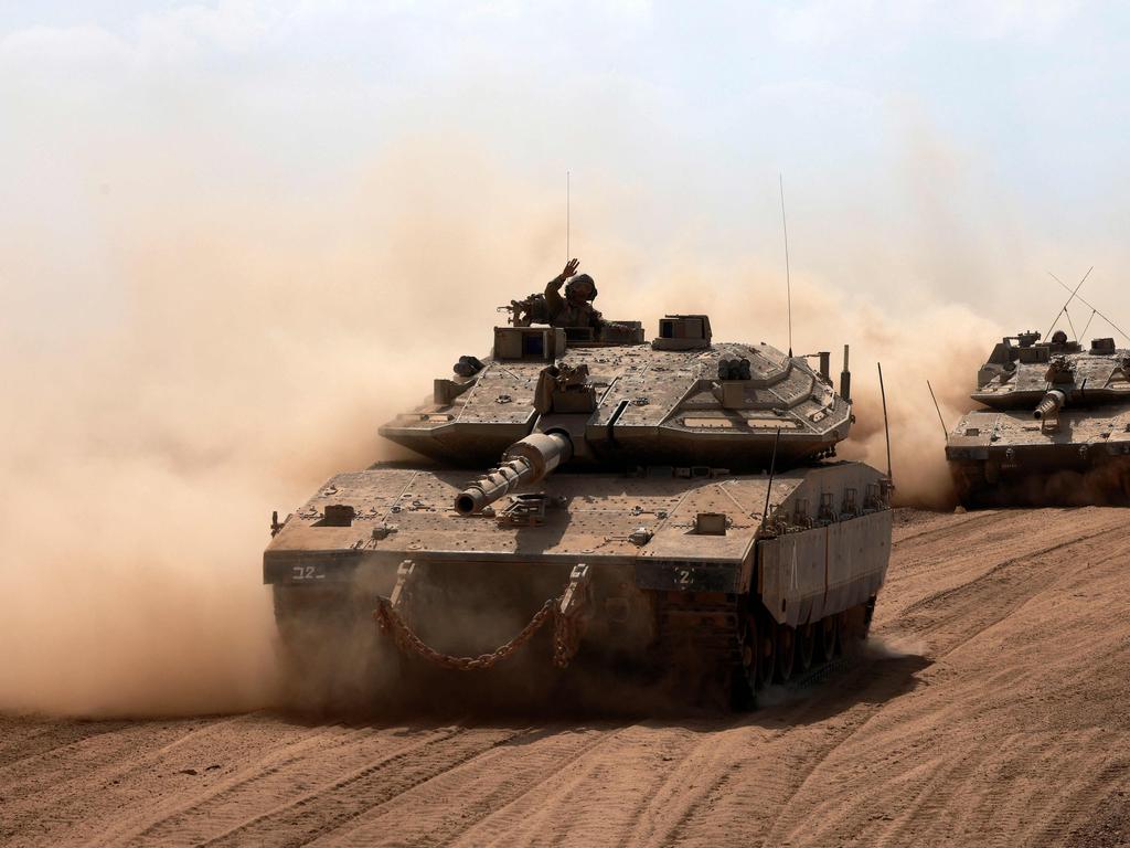 An Israeli army Merkava battle tank deploys with others along the border with the Gaza Strip in southern Israel. Picture: Menahem Kahana/AFP