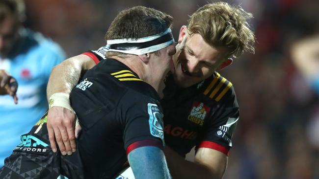 Damian McKenzie (right) congratulates Chiefs temmate Brodie Retallick on scoring against the Waratahs.