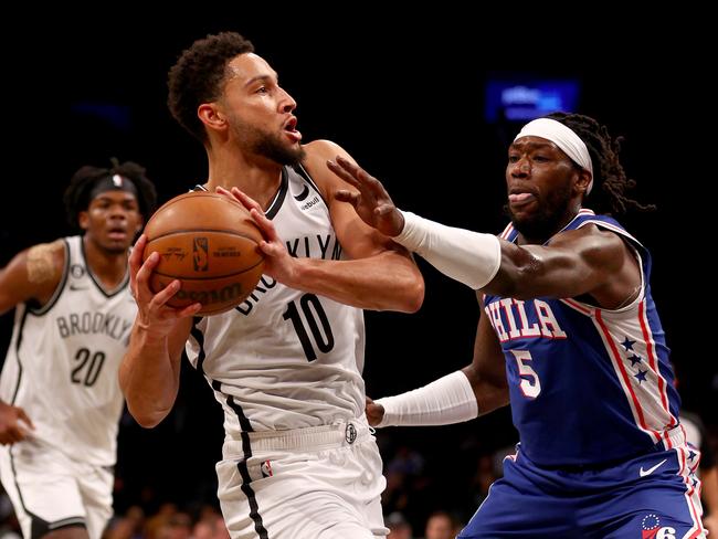 NEW YORK, NEW YORK - OCTOBER 03:  Ben Simmons #10 of the Brooklyn Nets tries to keep the ball from Montrezl Harrell #5 of the Philadelphia 76ers in the first half during a preseason game at Barclays Center on October 03, 2022 in the Brooklyn borough of New York City. NOTE TO USER: User expressly acknowledges and agrees that, by downloading and or using this photograph, User is consenting to the terms and conditions of the Getty Images License Agreement. (Photo by Elsa/Getty Images)