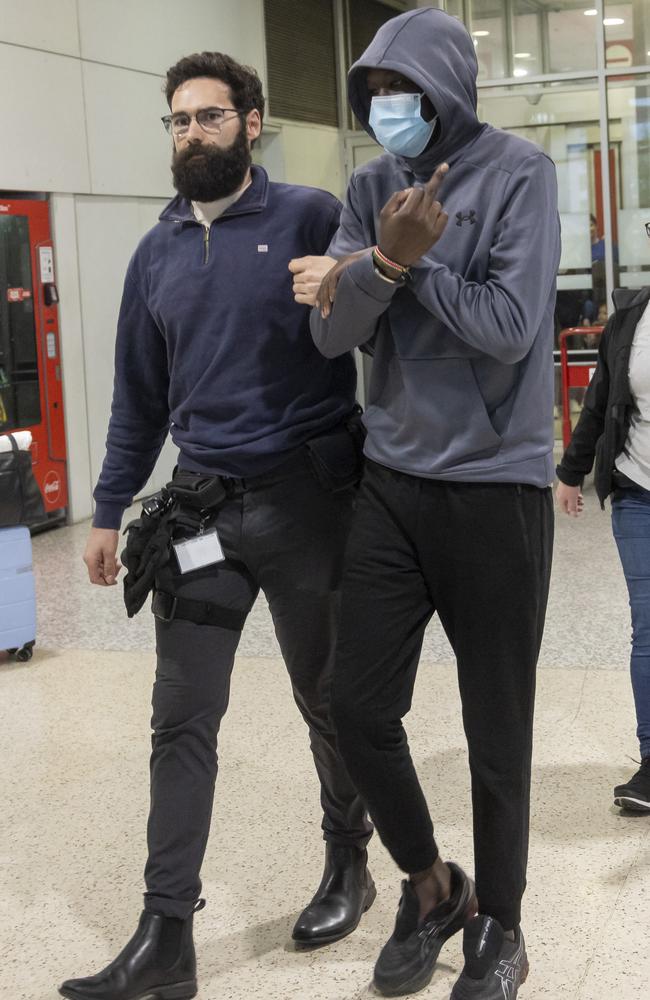 One of the men gave a photographer the middle finger. Picture: Wayne Taylor