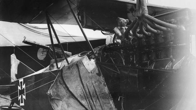 A teddy bear mascot sits atop the engine of a German A.E.G. C. IV aircraft, circa 1917. Picture: Australian War Memorial print ID B01863