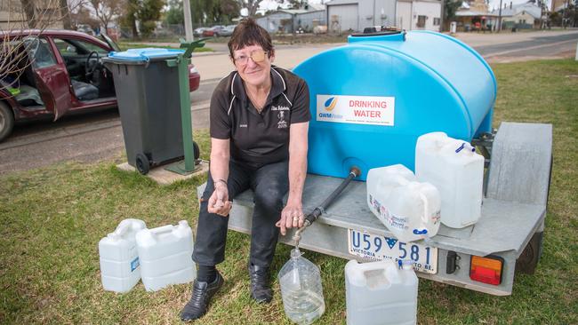 Desperate for clean water, Ultima resident Sonia Cunning is among locals who has to fill up bottles from a tank in the centre of town to get through each week. Picture: Jason Edwards