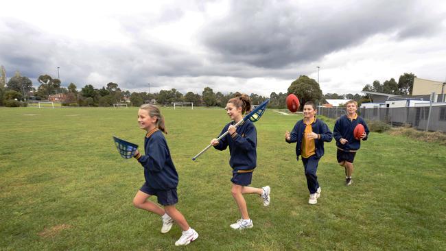 Orchard Grove Primary School students Jess, Leah, Declan, and Angus play on the oval.