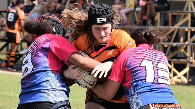 Akayla Weston is met by Harmony Passi and Evoltia Tuala. The Herbert River Junior Rugby League Club U15 girls’ teams versus Western Lions of Townsville at Artie Gofton Oval in Ingham on Saturday. Picture: Cameron Bates